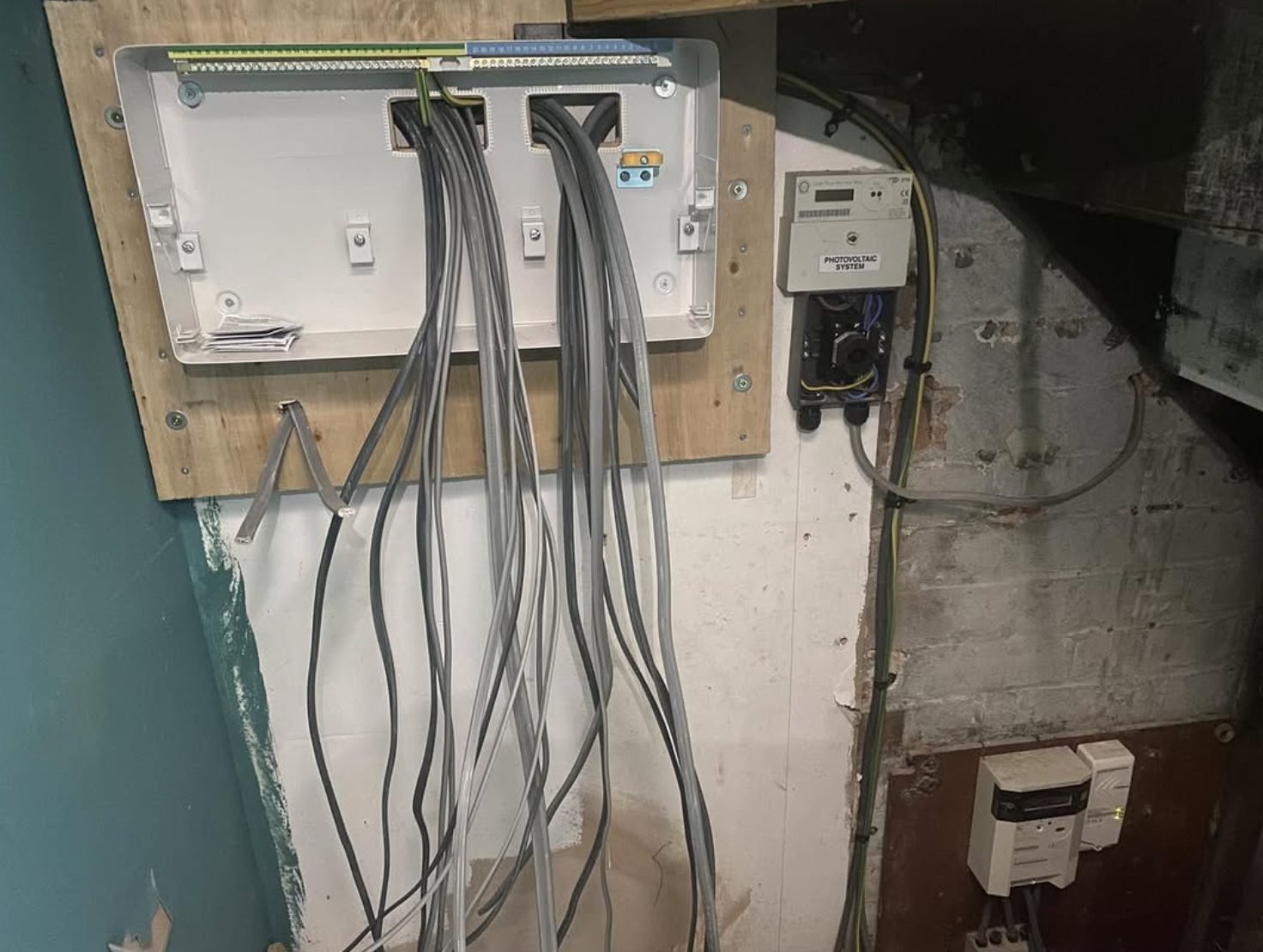 Consumer unit enclosure being fitted next to a photovoltaic generation meter